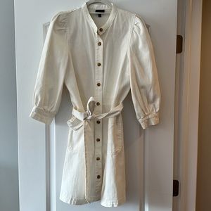 Adorable cream mini with puff sleeves and tortoise buttons!